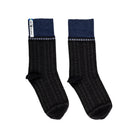 A pair of blue and black patterned merino wool socks.