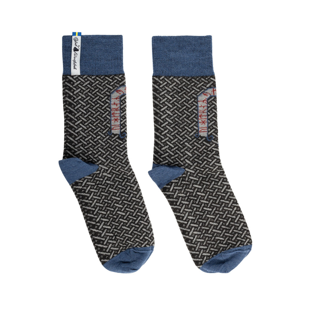 A pair of blue and grey patterned merino wool socks.