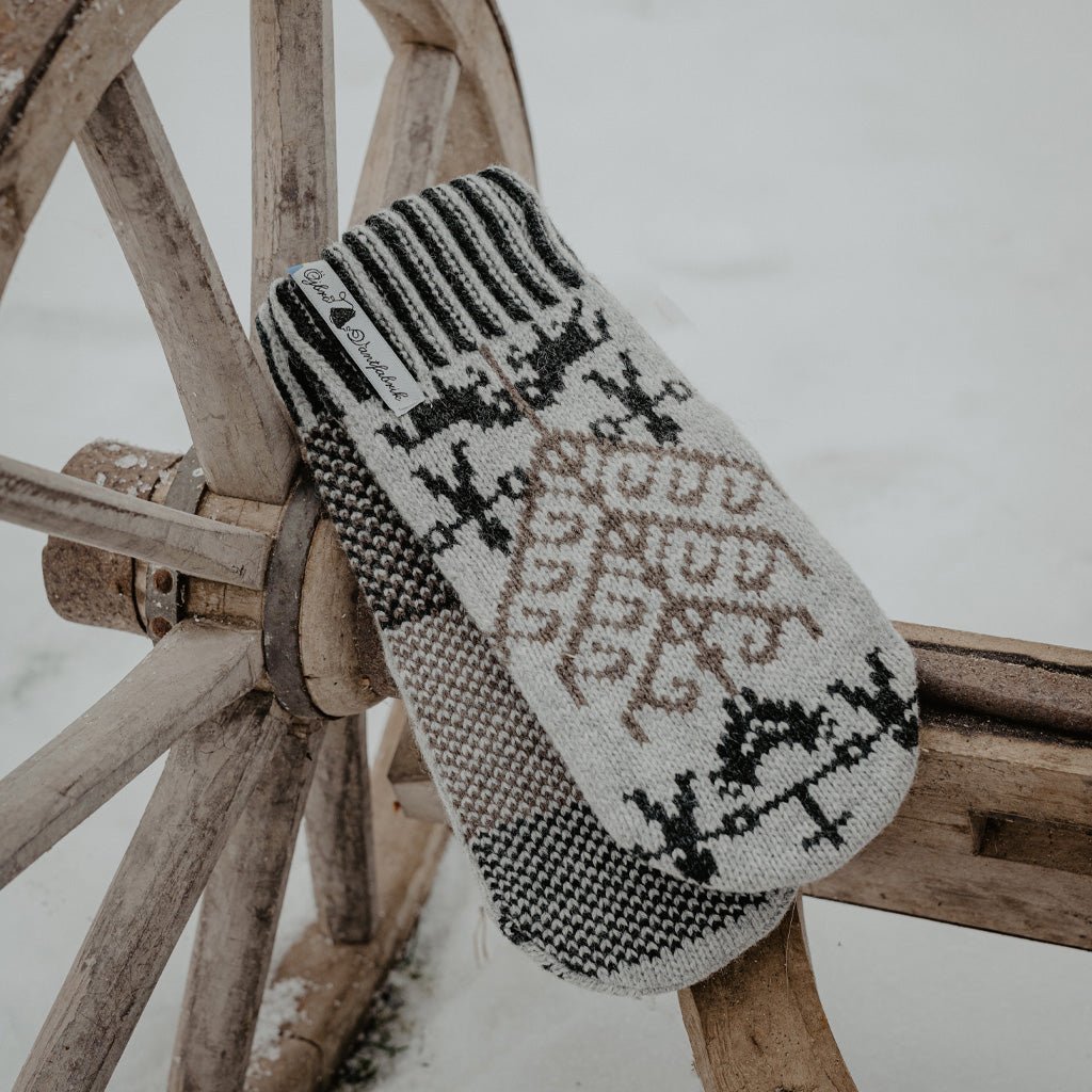 Wooden fixture with gray wool mittens resting on top.