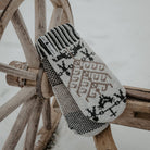 Wooden fixture with gray wool mittens resting on top.