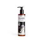 Pump bottle of hand and body cream on white background.
