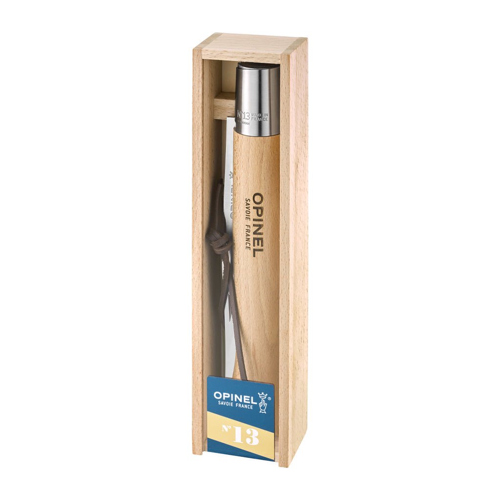 Side view of an Opinel giant knife packaged in wooden gift box on white background.