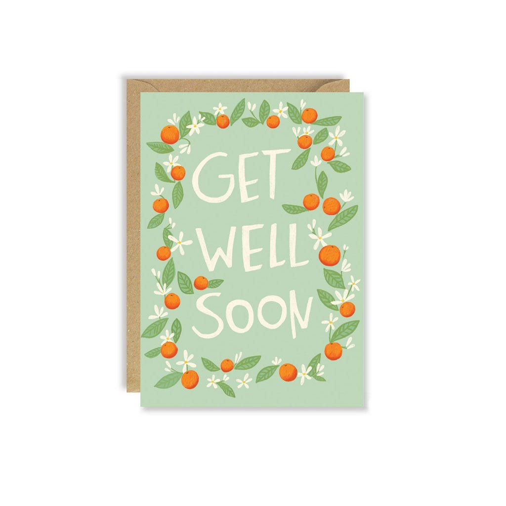 Greeting card featuring an orange blossom wreath and the text Get Well Soon, paired with a kraft envelope.