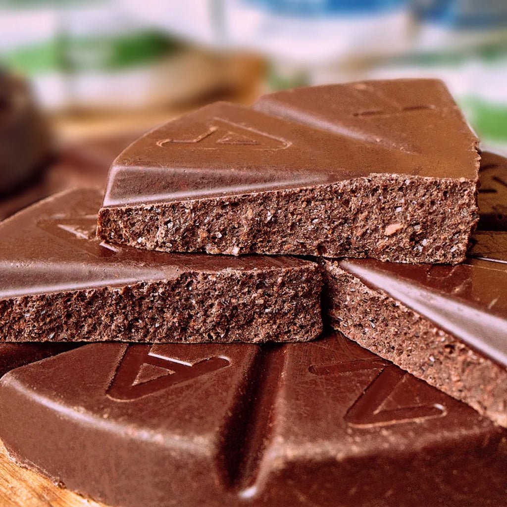 Close-up of Taza chocolate disc with a brand logo on a blurred background