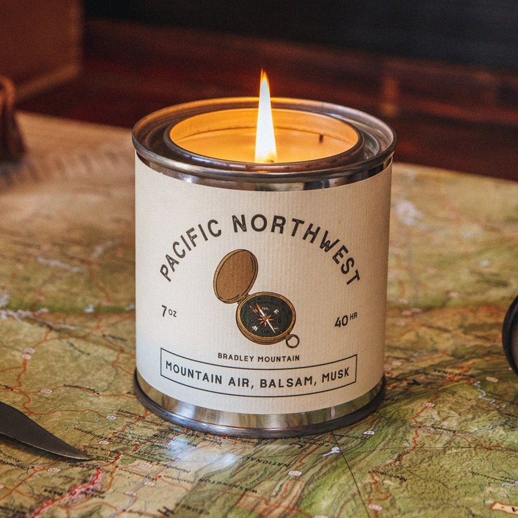 Candle in a Pacific Northwest-themed canister on a map