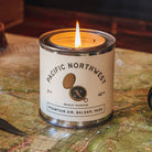 Candle in a Pacific Northwest-themed canister on a map