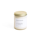 Candle jar labeled 'Palo Santo' with a gold lid on a white background