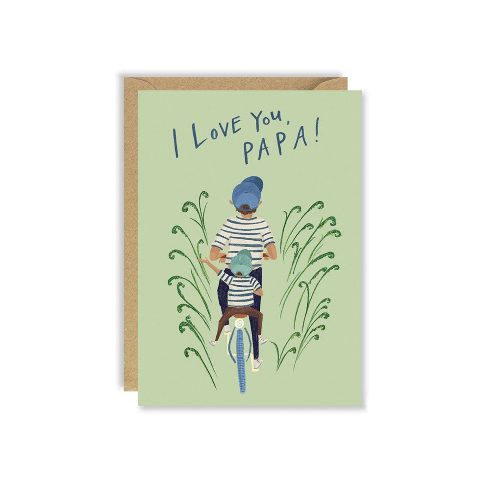 Green greeting card with father and child on bike illustration with kraft envelope on white background