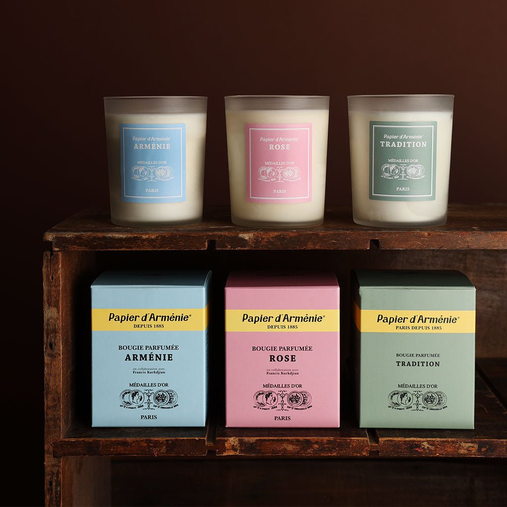 Three Papier d'Armenie candles in various scents on dark background