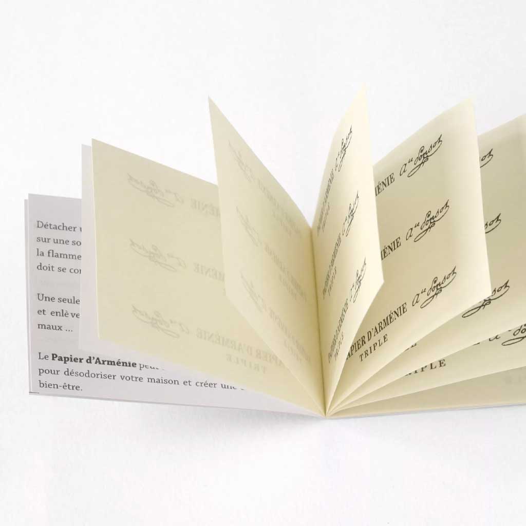 Booklet of incense paper strips on white background