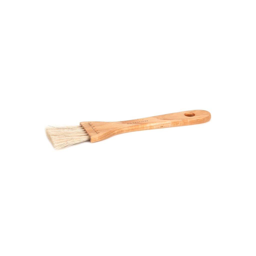 Wooden pastry brush with light bristles on white background