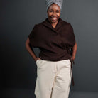 Woman wearing merchant and mills sewn clothing against dark background