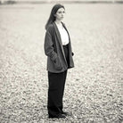 Woman wearing merchant and mills sewn clothing on rocky beach