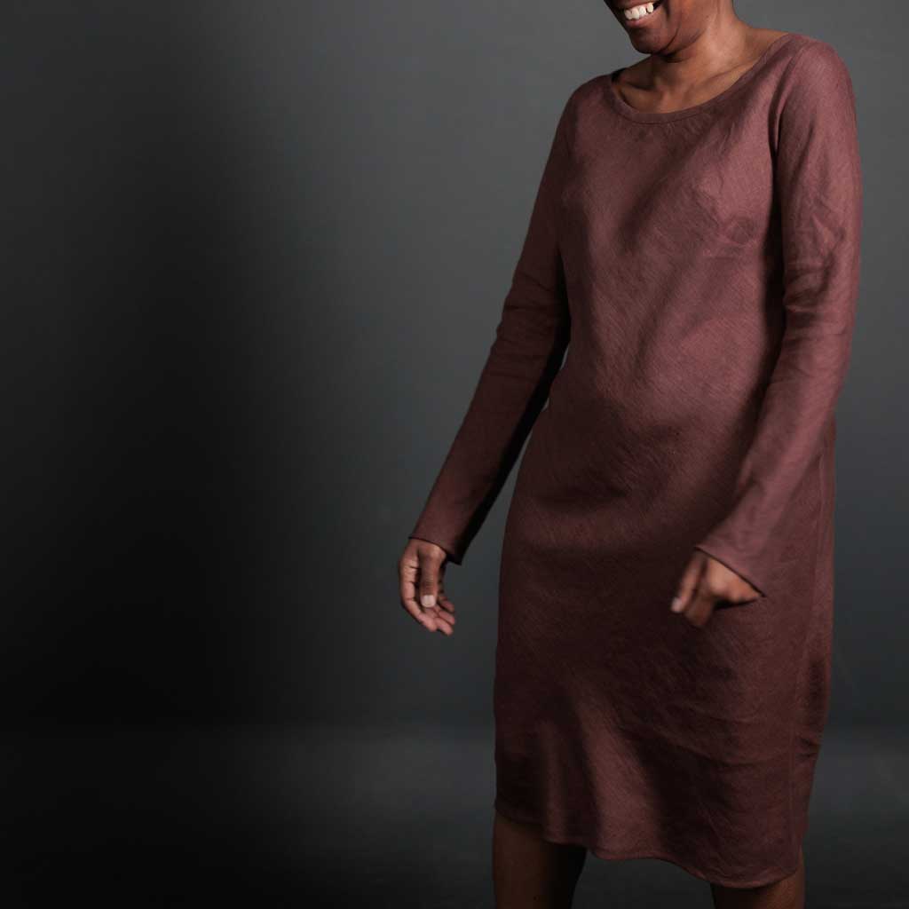 Woman wearing merchant and mills sewn clothing against dark background