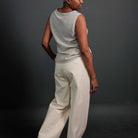 Woman wearing merchant and mills sewn clothing against dark background