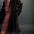 Woman wearing merchant and mills sewn clothing against dark background