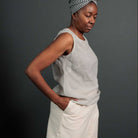 Woman wearing merchant and mills sewn clothing against dark background