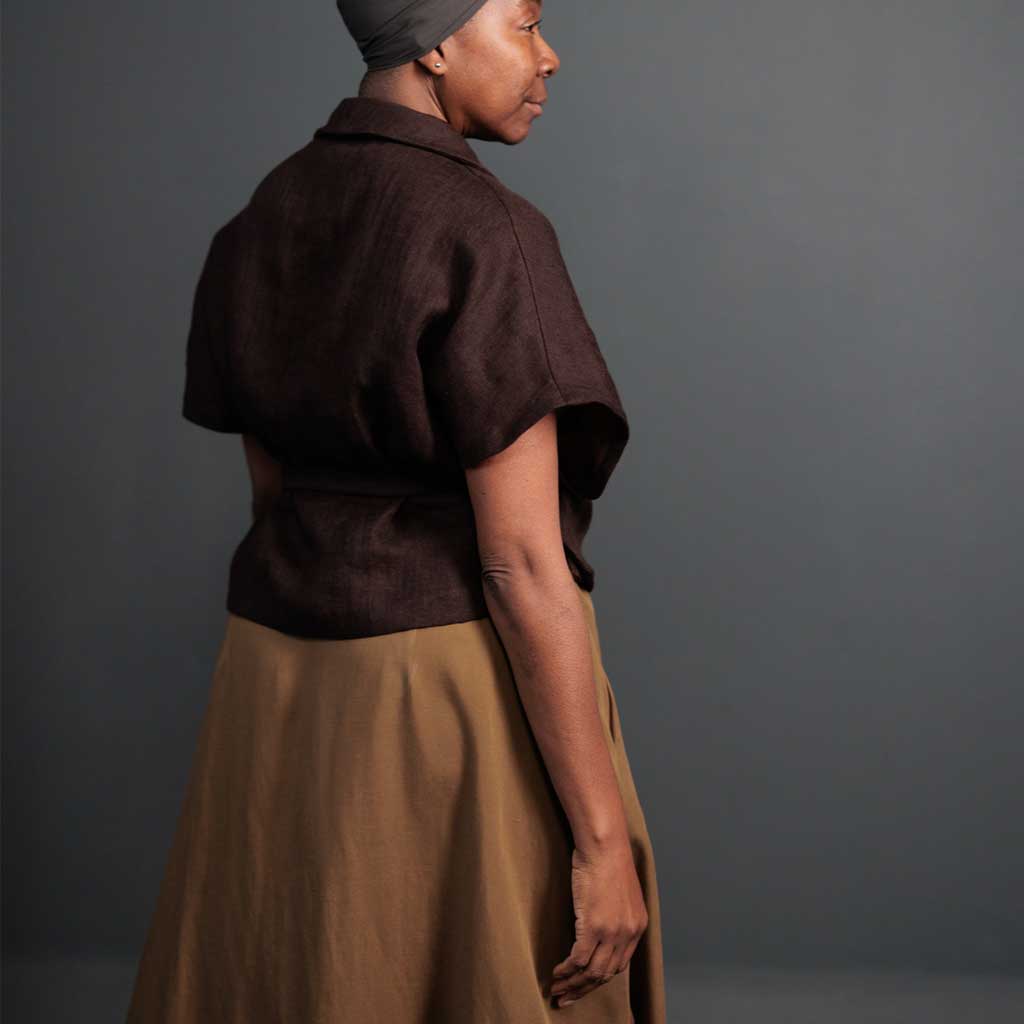 Woman wearing merchant and mills sewn clothing against dark background
