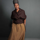 Woman wearing merchant and mills sewn clothing against dark background