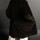 Woman wearing merchant and mills sewn clothing against dark background