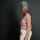 Woman wearing merchant and mills sewn clothing against dark background