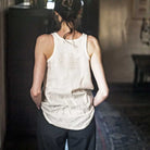 Woman wearing merchant and mills sewn clothing against dark background