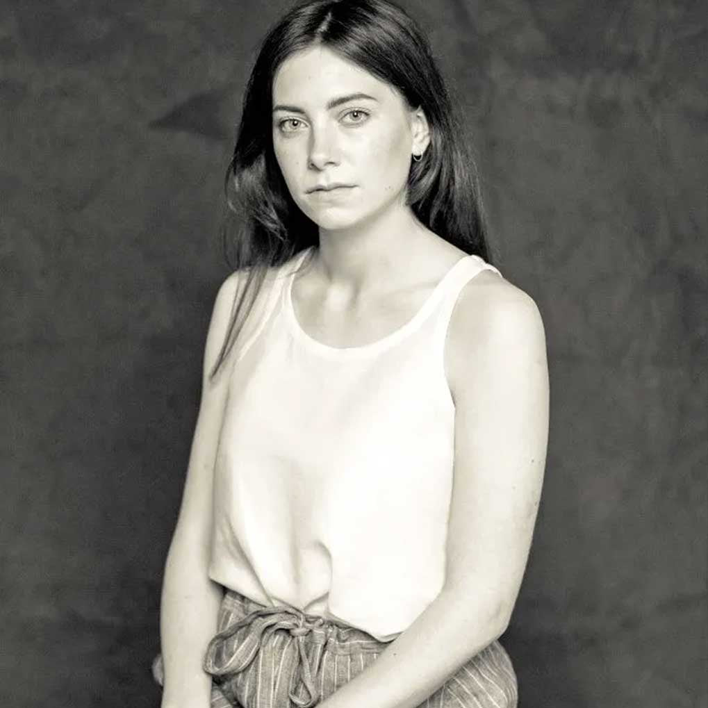 Woman wearing merchant and mills sewn clothing against dark background