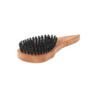 Palm-sized wooden hairbrush with dark boar bristles on white background