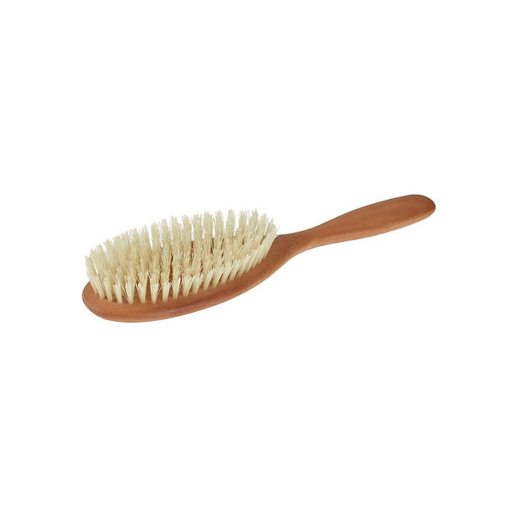 Pear wood hairbrush with light colored boar bristles on white background