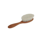 Small wooden brush with soft, white goat hair bristles and a rounded brush head. There is a small logo on the handle.