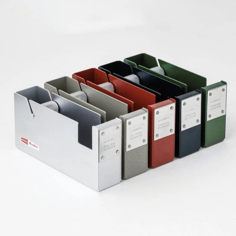 Set of colorful large steel tape dispensers in a row on a white background