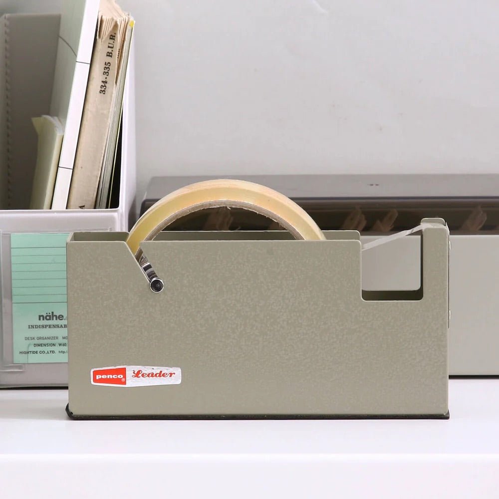 Desk organizer with tape dispenser on a desk.