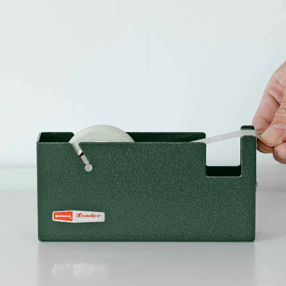 Green tape dispenser with a hand pulling out tape on a white background
