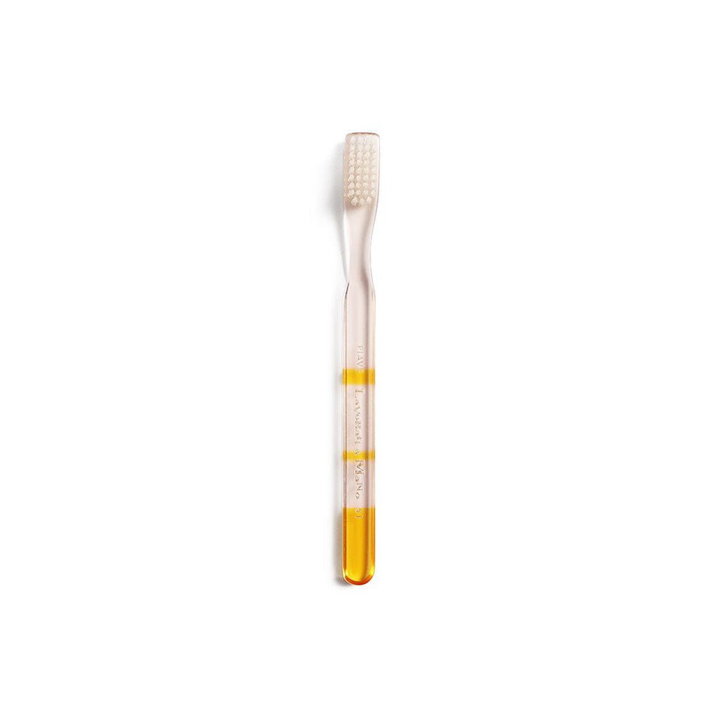 Yellow and clear toothbrush with gradient color handle on a white background