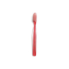 Red and clear striped toothbrush on white background