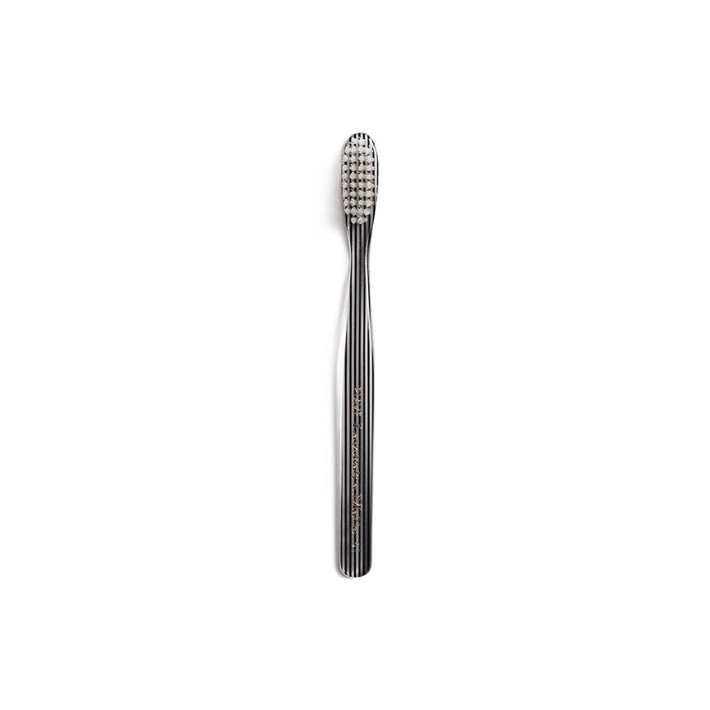 Black and clear striped toothbrush on white background