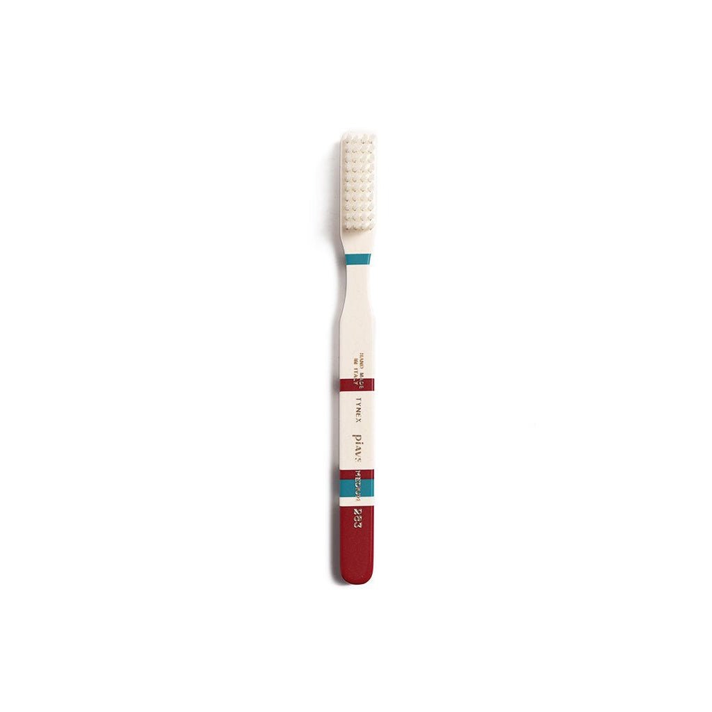Burgundy and cream toothbrush on white background
