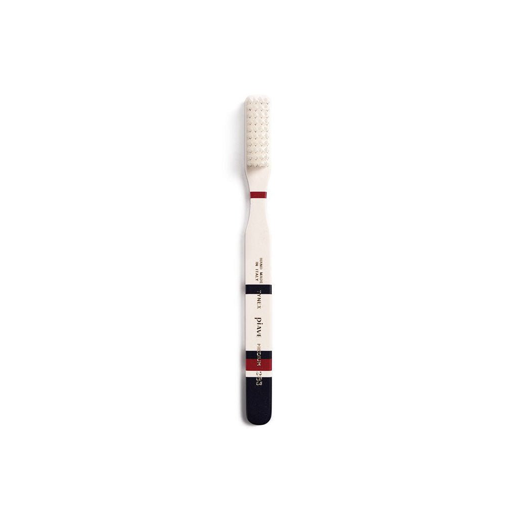 Midnight blue and cream toothbrush on white background