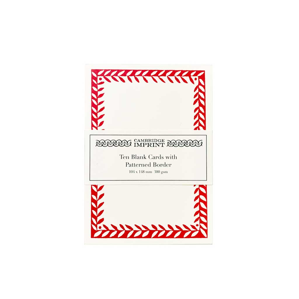 Pack of ten blank cards with red patterned borders on a white background