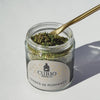 Video of spoon dipping into jar of Herbes de Romance blend on white background