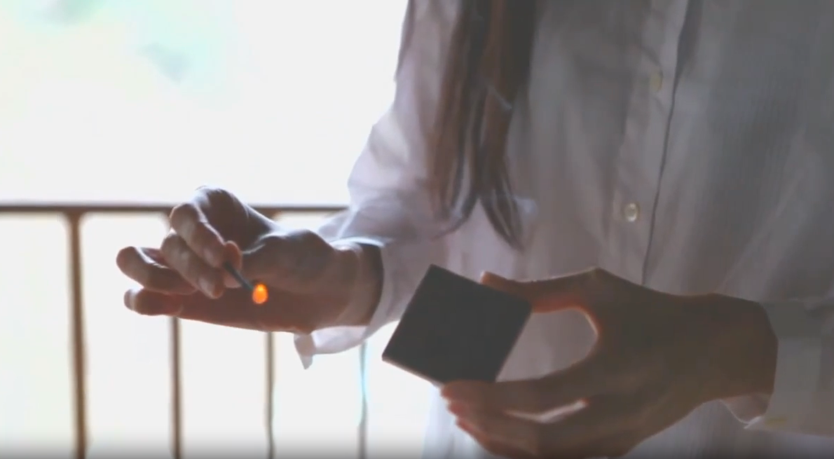 Video of person striking Hibi incense match against matchbox in living room