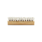 Wooden pet lint brush with rubber bristles on white background