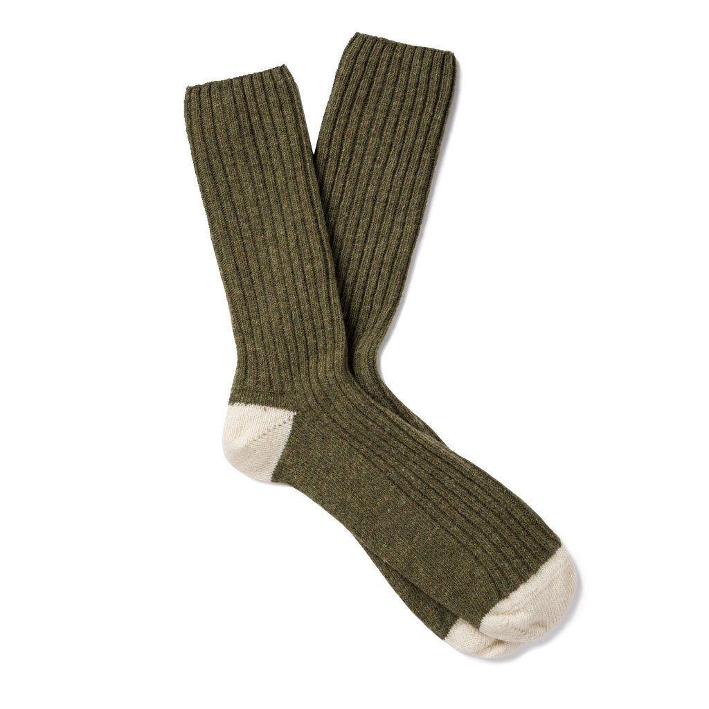 Pair of green wool socks with cream-colored toes and heels.
