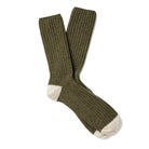 Pair of green wool socks with cream-colored toes and heels.