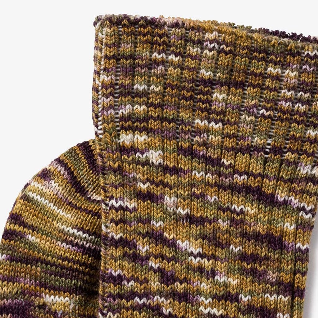 Close-up of multicolored socks in a blend of moss green, golden brown, and cocoa.