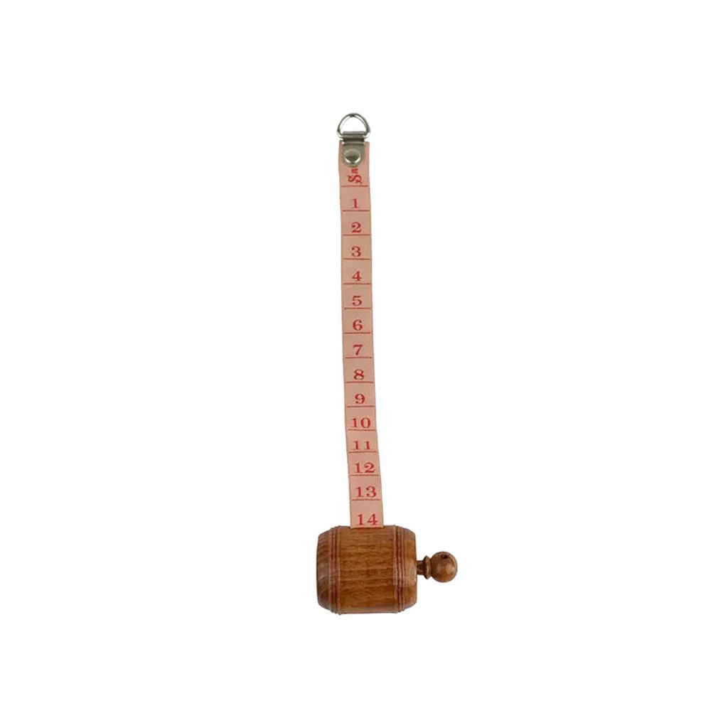 Wooden measuring tape with red ribbon unfurled.