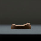 Wooden pen rest on dark background