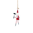 A Santa ornament holding a hammer and nails, hanging on a twine string.