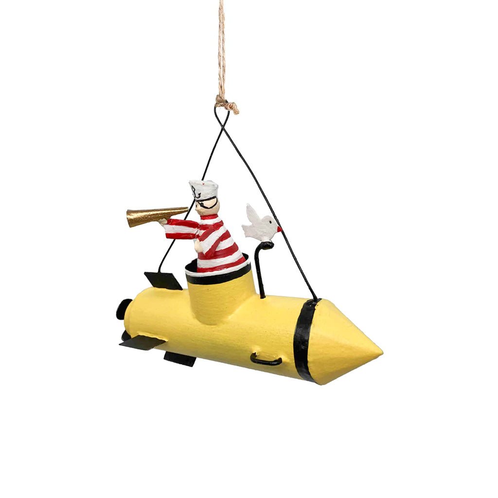 A metal ornament of a sailor in a yellow submarine.
