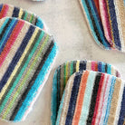 Assorted sets of scrub cloths on table